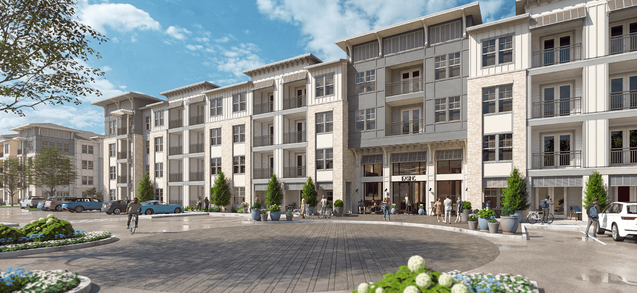 A modern apartment complex with a central courtyard and landscaping.